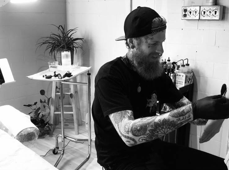 Karl Otto tattooing in studio